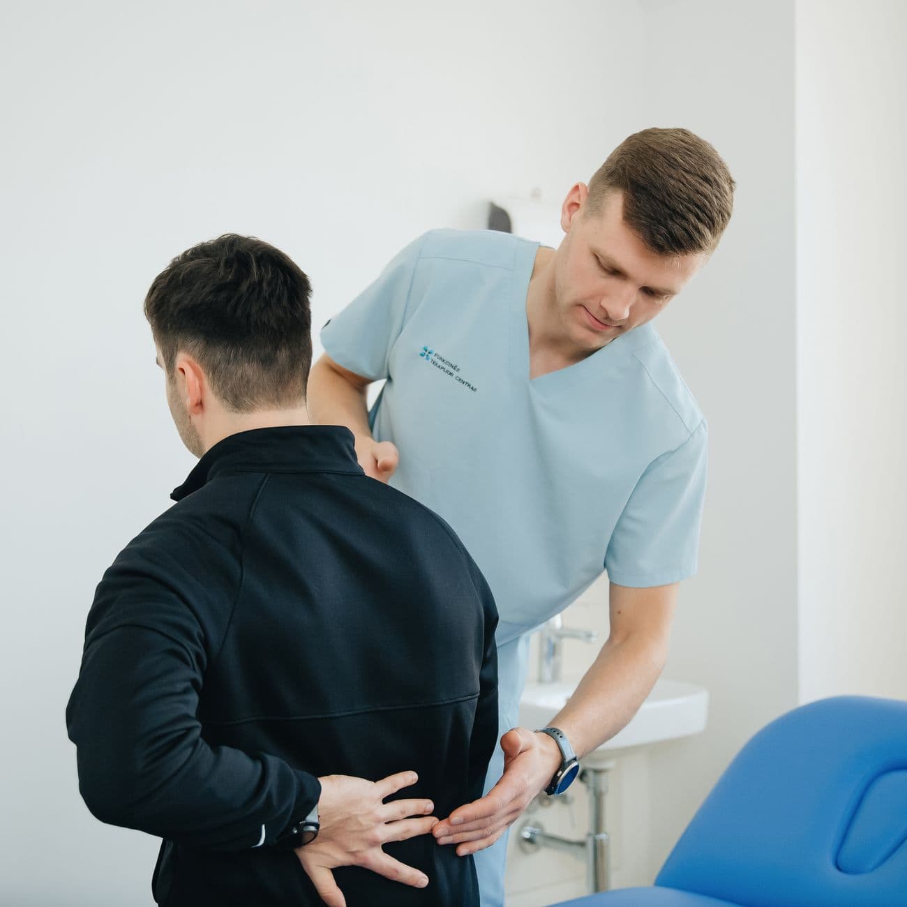 Physiotherapist treating a patient with back pain